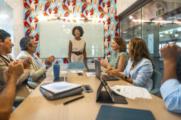 Diverse business colleagues showing appreciation for a successful presentation in a modern