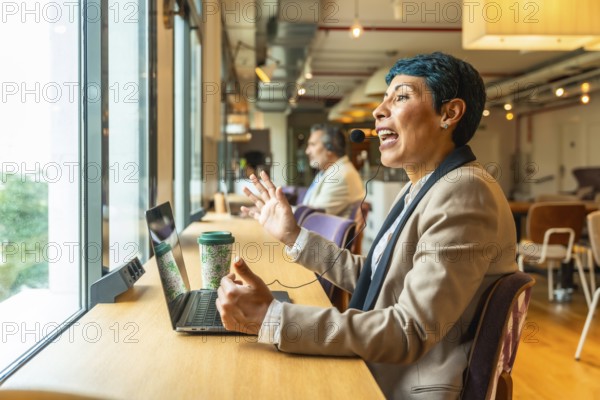 Business professional with headset actively communicating during an online video conference from a
