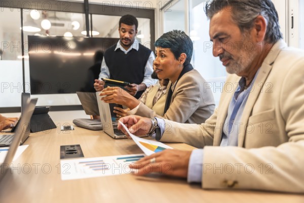 Business colleagues of diverse ages and ethnicities collaborating during an important meeting,