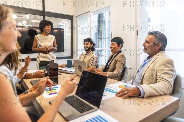 Multiracial team of business colleagues actively collaborating and discussing project strategies
