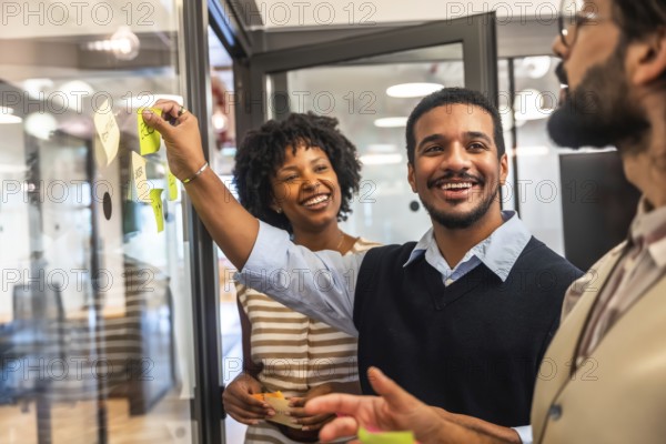 Diverse business professionals collaborating in a modern office, cheerfully sharing innovative