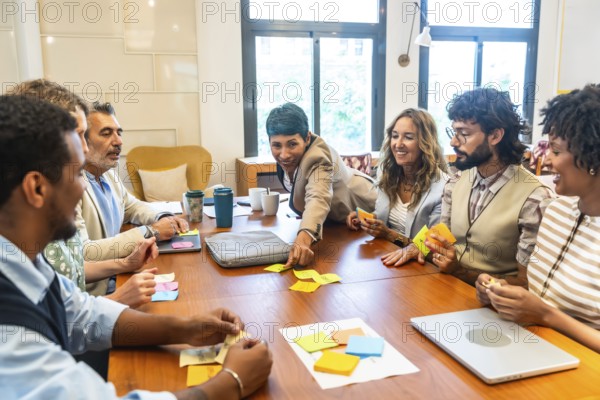 Diverse business team collaborating energetically around a table, exchanging ideas, brainstorming