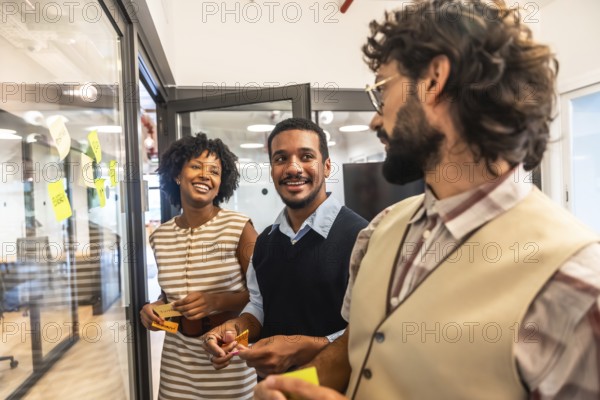 Diverse business professionals collaborating happily, exchanging creative ideas, and planning