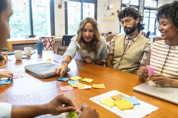 Diverse team of professionals collaborating, strategizing, and sharing concepts using colorful