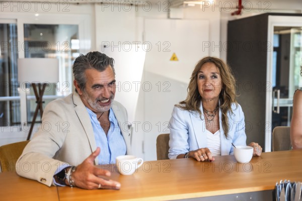 Diverse business colleagues engaging in a discussion and creative conversation during an informal