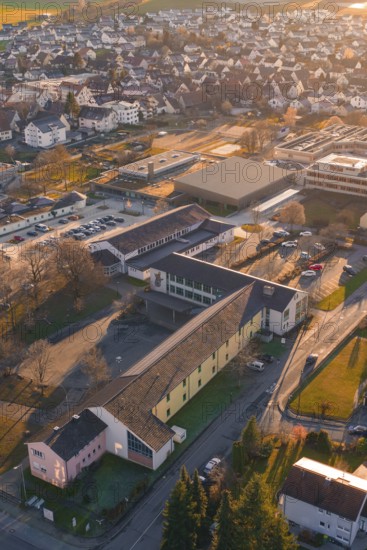 Rural aerial view with school buildings and roads in an autumnal atmosphere, Althengstett, Calw