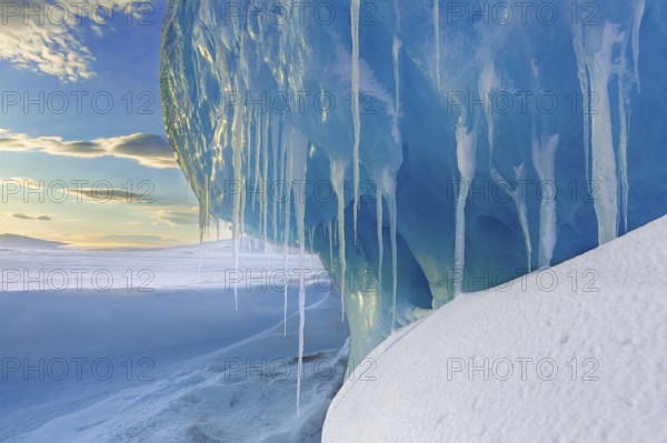 Melting icicles in snow covered Arctic landscape at Mohnbukta, bay at the western shore of