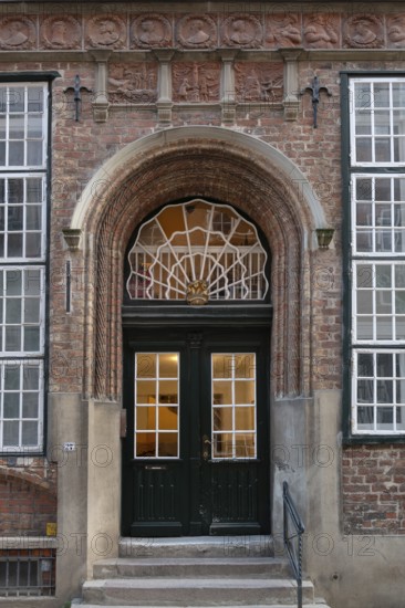 Entrance of a historic residential building with terracotta decoration, built around 1560,
