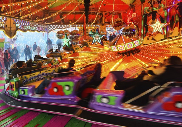 People on the Musik-Express ride at the All Saints Fair, the biggest old town fair in Europe,