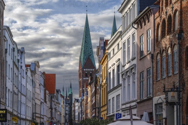 Shopping street with historic houses and the towers of St. Mary's Church, Hanseatic City of Lübeck,