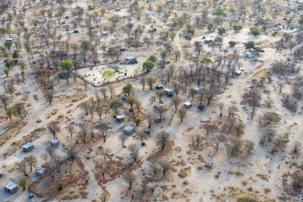 Settlement, simple house and fence, dry savanna landscape, near Maun, aerial view, Okavango Delta,