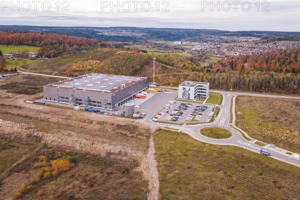 Large warehouse surrounded by hills and autumn trees, modern architecture, new Lindenrain