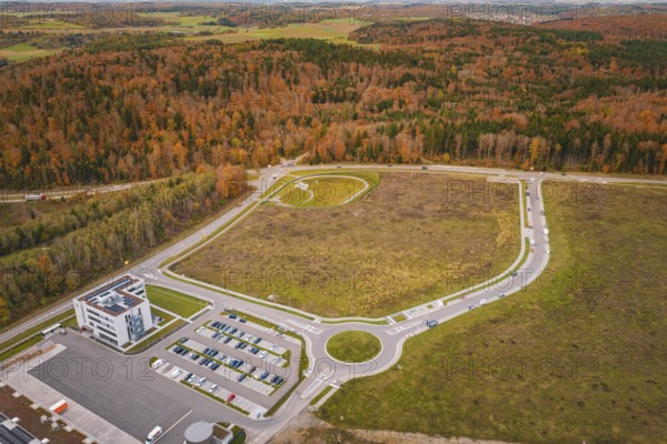 Aerial view of a roundel with surrounding buildings and autumn trees, new Lindenrain industrial