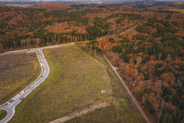 Wide fields and autumn forests criss-crossed by paths and roads, new Lindenrain industrial park,