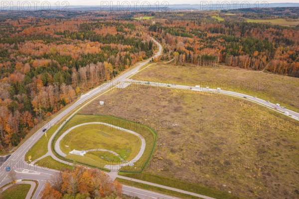 Extensive autumn landscape with crossroads surrounded by forests, new Lindenrain industrial park,
