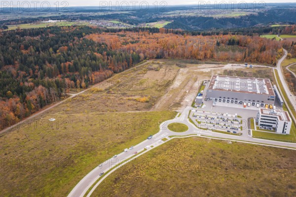 Industrial area with modern building on the edge of the forest and autumn landscape, new Lindenrain