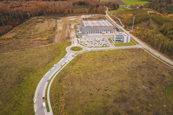 Industrial plant with surrounding roads and parking areas in an autumn landscape, new Lindenrain