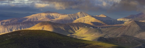La Geria wine region, behind the volcanic formation Los Ajaches at sunrise, Lanzarote, Canary