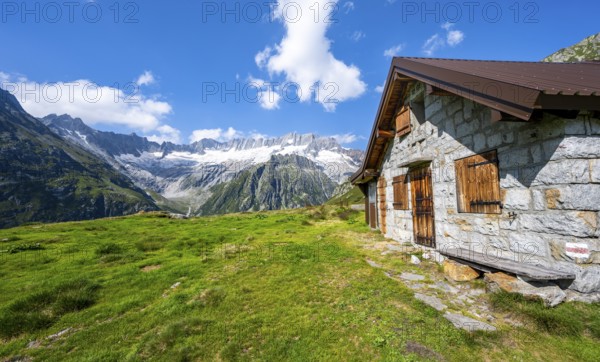 Alpine hut in picturesque mountain landscape with dammastock and damma glacier, Göscheneralp,