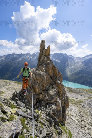 Crocodile rock formation, mountaineer on rope bridge in the Crocodile Mountain Lake via ferrata on