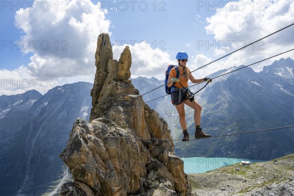 Crocodile rock formation, mountaineer on rope bridge in the Crocodile Mountain Lake via ferrata on