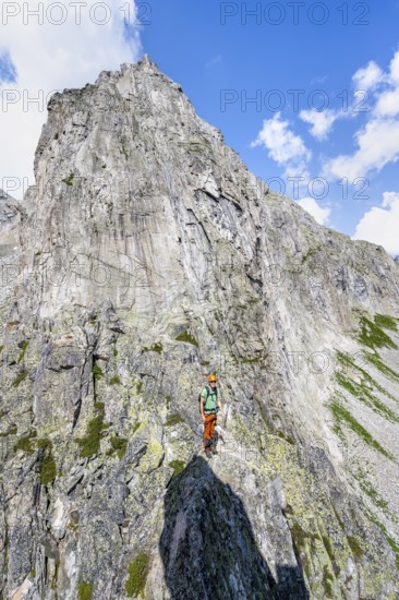 Mountaineers on the secure via ferrata Crocodile Mountain Lake at Bergseeschijen-Vorbau,