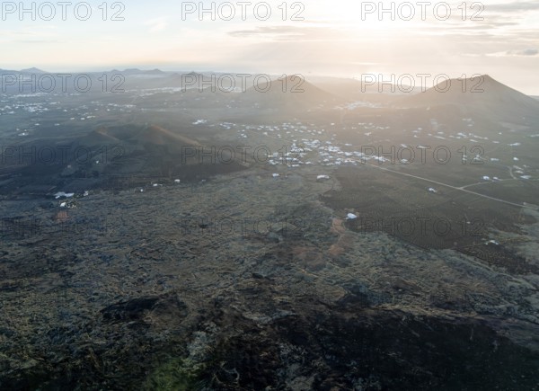 Picturesque volcanic landscape with volcanic craters and lava fields in the morning light, white