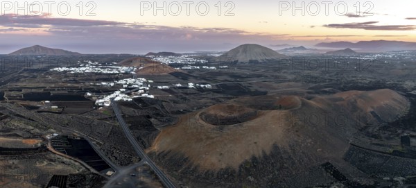 Picturesque volcanic landscape with volcanic craters Montaña de la Tabaiba at sunrise, Parque