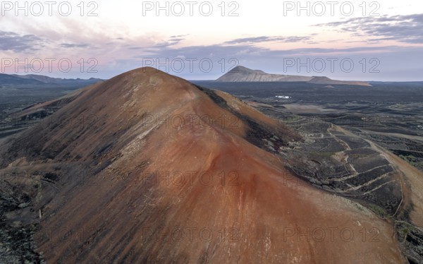 Red volcano Montaña Corujo, picturesque volcanic landscape with volcanic craters at sunrise, Parque