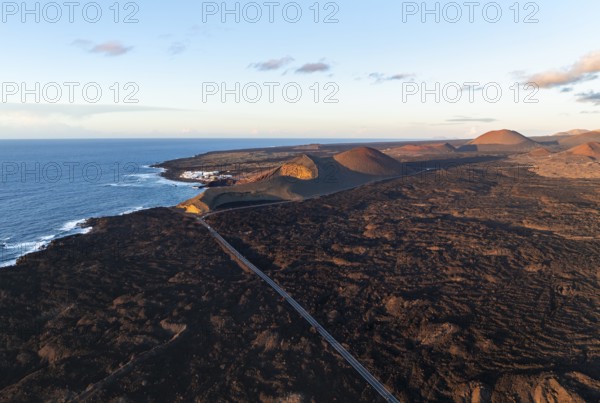 Coast with lava fields near Charco Verde, volcanic landscape in evening light, aerial view,
