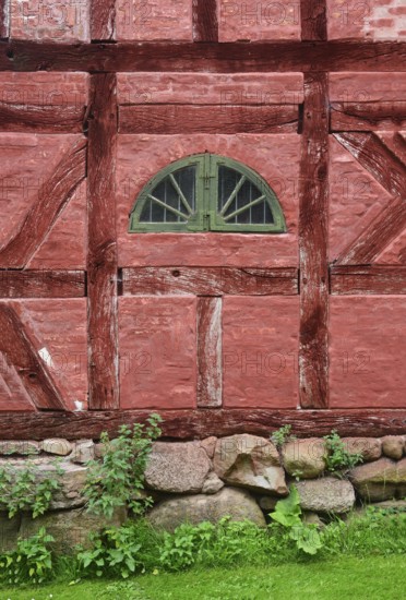 Green window in a wall in a red half-timbered house in Den gamle by, The old Funen village, open