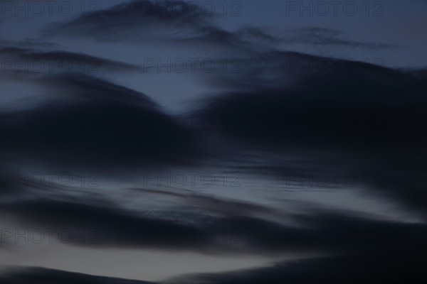 Dark clouds sweep across the sky at dusk, Peenetal nature park Park, Mecklenburg-Western Pomerania,
