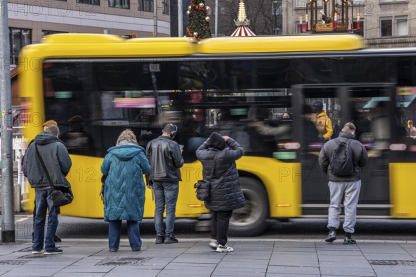 Bus station at Essen main station, Ruhrbahn bus leaves, passers-by wait, Essen, North