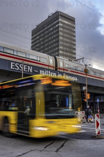 Ruhrbahn bus leaves the bus station at Essen main station, ICE train on track 1 in the train