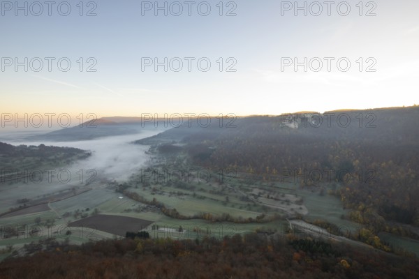 Sunrise with fog in the Neidlinger Valley with a view of the Reussenstein castle ruins. Swabian