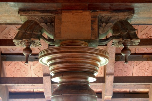 Decorative wood structure with carved details on a ceiling, traditional architectural style, Kalari