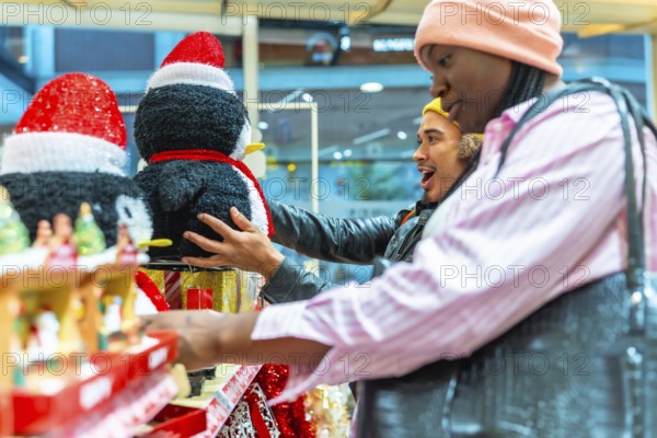 Diverse couple browsing holiday decorations in a store, a man looking surprised and excited while