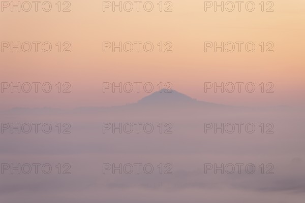 Hohenstaufen mountain in golden morning light, Aichelberg. Spectacular dawn over the foggy