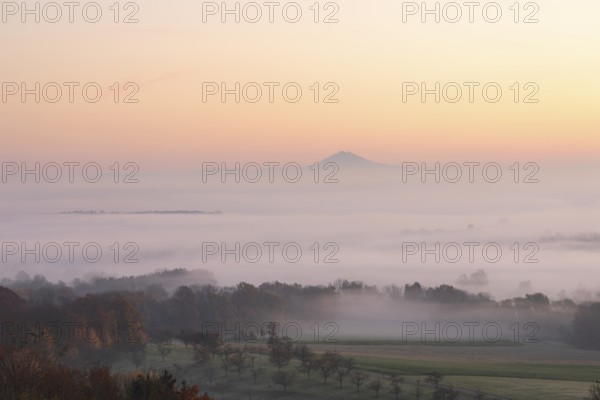 Hohenstaufen in the golden morning light, Aichelberg. Spectacular dawn over the foggy foothills of