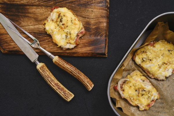 Succulent pork chops are baked to perfection in an air-fryer, topped with melted cheese, and