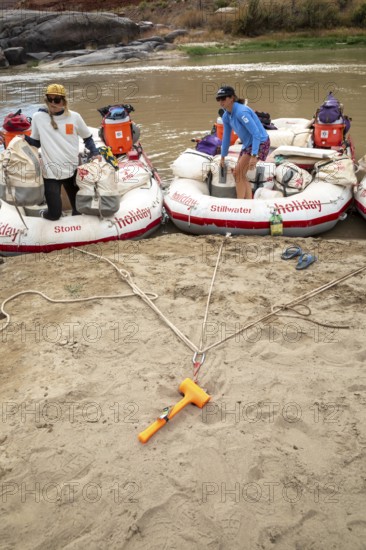Loma, Colorado - An anchor holds rafts on the shore of the Colorado River during a river rafting