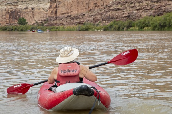 Loma, Colorado - A woman paddles an inflatable kayak, part of a river rafting trip on the Colorado