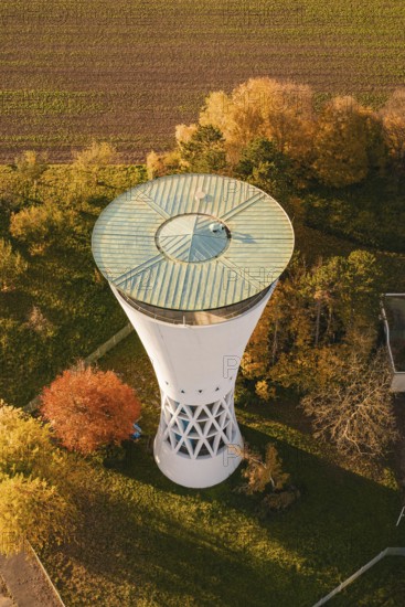 Aerial view of a water tower surrounded by colorful autumn leaves and fields, Möglingen water