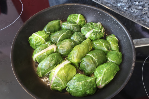 Swabian cuisine, roast tree frogs, stuffed Swiss chard in pan, preparation, stove, ceramic hob,