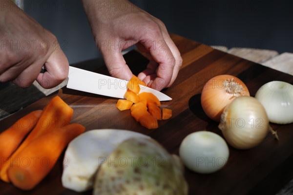 Southern German cuisine, preparing vegetables, cutting raw carrots, celery, onions, vegetarian,