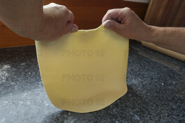 Swabian cuisine, preparing strudel dough, removing raw potato dough, countertop, baking, out of the