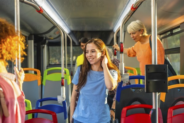 Diverse commuters stand and ride a bright city bus, holding handrails and chatting as they travel