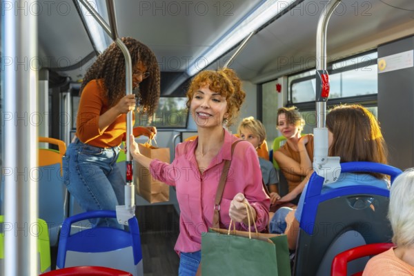 Diverse group of women and other people traveling on a public transport bus, some carrying shopping