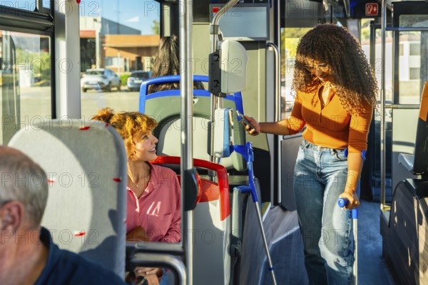 Young woman with crutches using contactless payment with smartphone to buy a ticket on public