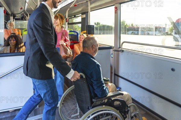 Man supporting a passenger in a wheelchair, providing assistance while boarding public transport,